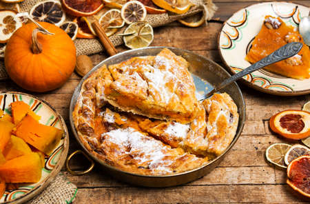 Homemade pumpkin pie with various ingredients tabletopの写真素材