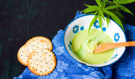 Butter with cannabis plant in a bowl top viewの写真素材