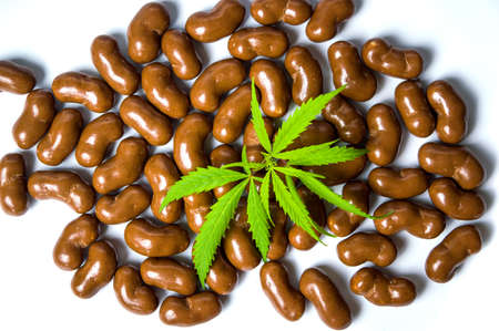 Chocolate candy with marijuana cannabis plant top viewの写真素材