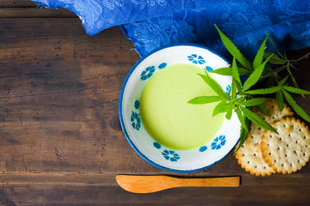 Butter with cannabis plant in a bowl top viewの写真素材