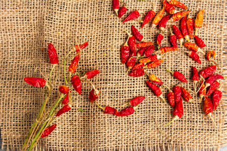 Dried red peppers on a rustic background top viewの写真素材