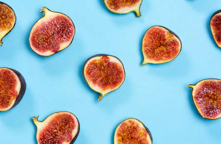Fresh figs on a blue background flat layの写真素材