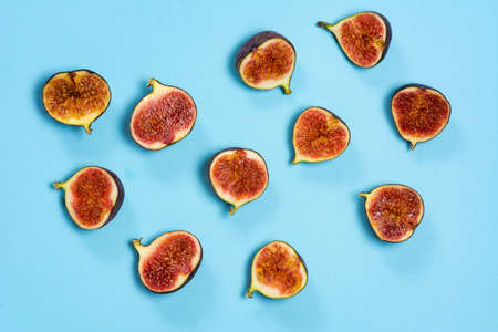 Fresh figs on a blue background flat layの写真素材