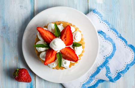 Homemade strawberry dessert with sweet cream in a cupの写真素材