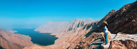 Woman enjoying view over Fjord Khor Najd in Musandam Omanの写真素材