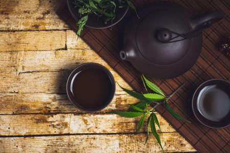 Marijuana herbal tea and cannabis leaves tabletopの写真素材