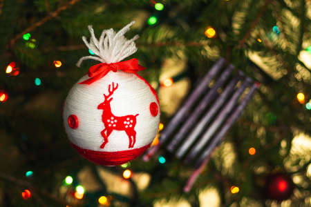 Festive decorations hanging from the Christmas tree closeupの写真素材