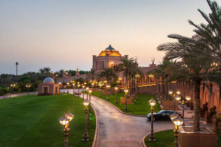 Abu Dhabi, United Arab Emirates - November 1, 2019: Emirates palace in a beautiful yard, one of the most famous landmarks in Abu dhabi at sunsetのeditorial素材
