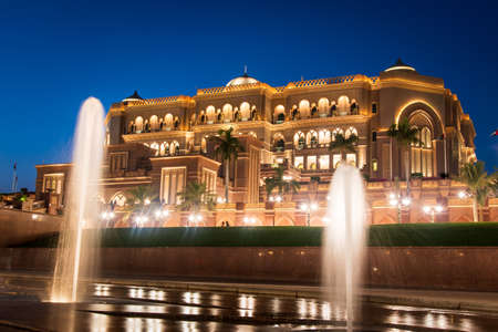 Abu Dhabi, United Arab Emirates - November 1, 2019: Emirates palace in Abu dhabi reflected on the ground level fountain at blue hourのeditorial素材