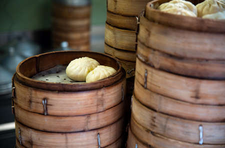 Fresh baozi in bamboo steamer on Chinese Asian food street