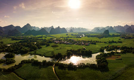 Karst landscape and agricultural fields in Guangxi province at south China aerial view at sunsetの写真素材