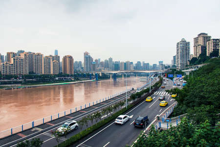 Chongqing, China - July 23, 2019: Multilayer roads and traffic by the Yangtze river in Chongqing, Chinaのeditorial素材