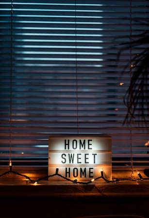 Home Sweet Home sign on the windowの写真素材