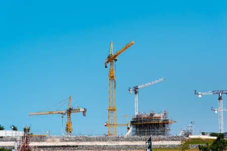 Tower Cranes on a construction site against blue sky