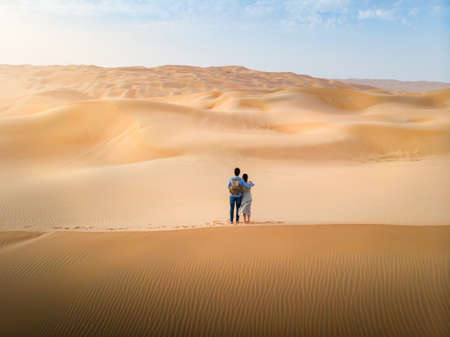 Couple enjoying romantic scenic sunset in a desert aerial viewの写真素材