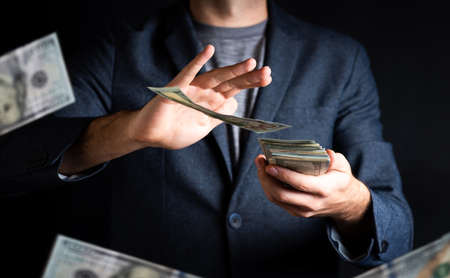 Businessman tossing moneyの写真素材