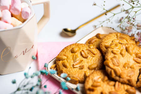 Group of cookies with peanuts on mat.