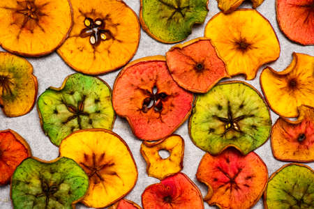 Colored dried apple chips snacks, creative homemade food flat layの写真素材
