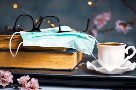 Spending time indoors in spring essentials of book and face maskの写真素材