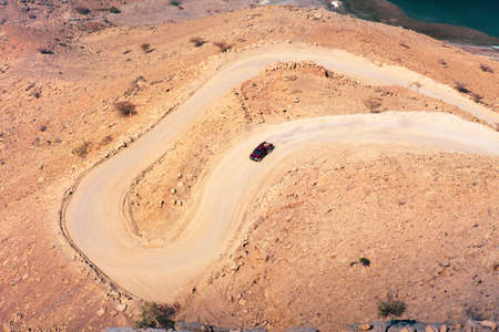 Car on the sand road at Fjord Khor Najd in Musandam Oman