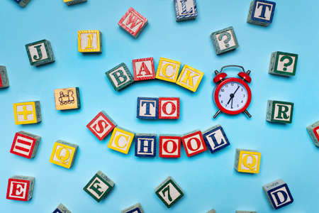 Back to school note written with wooden letters, education and alphabet abstract