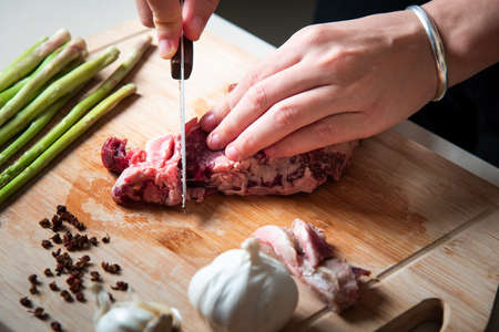 Woman cutting Wagyu Japanese beef steak on the cutting board closeupの写真素材