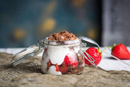 Strawberry parfait dessert in a glass jar closeupの写真素材