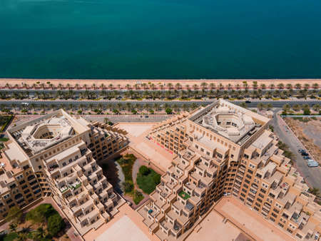 Marjan Island in emirate of Ras al Khaimah in the United Arab Emirates aerial view at sunrise of the characteristic man shaped skyline and waterfront architectureのeditorial素材