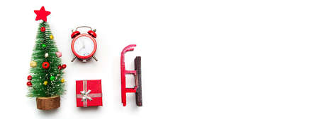 Winter Christmas and New Year symbols and decorations flat lay on white background isolated. Festive presents, toy tree, clock and otherの写真素材