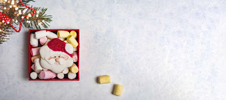 Christmas cookies and marshmallow on a table with winter holidays festive decorations and symbols top viewの写真素材