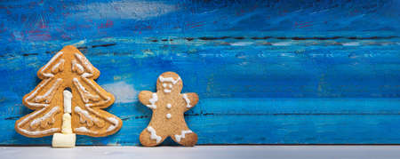 Christmas cookies on a table with winter holidays festive decorations and symbols on a blue wooden table top view with copy spaceの写真素材