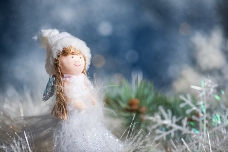 Toy angel and Christmas tree winter holiday festive background and ornamentsの写真素材
