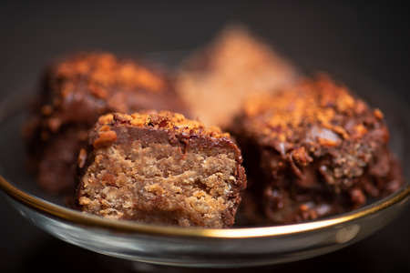 Homemade chocolate cake dessert with almonds on a dark background