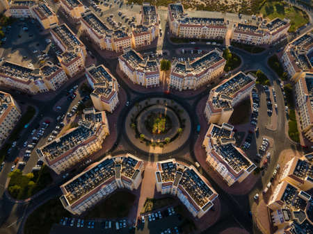 Roundabout and architectural symmetry of International City in Dubai, United Arab Emirates. Suburban country-themed architecture of residences in the UAE aerial viewの写真素材