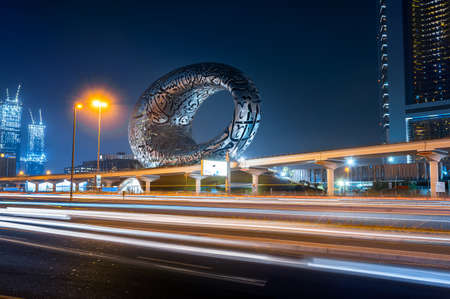Dubai, United Arab Emirates - March 31, 2021: The Museum of The Future in Dubai downtown built for EXPO 2020 scheduled to be held in 2021 in the United Arab Emirates above Sheikh Zayed road with lights trails at blue hourのeditorial素材