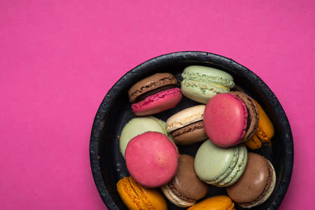 Macaron or macaroon sweet cookie desserts on pink backgroundの写真素材