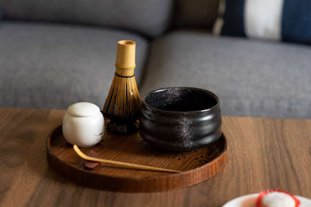 Matcha green tea bamboo set on a table at home ready for making teaの写真素材