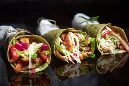 Homemade vegan tortillas with red beans, sweet potatoes, tomatoes and guacamole with sauces and...
