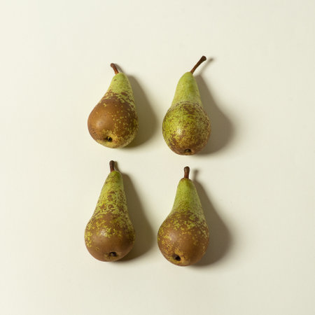 Few large, green, organic pears on a white background