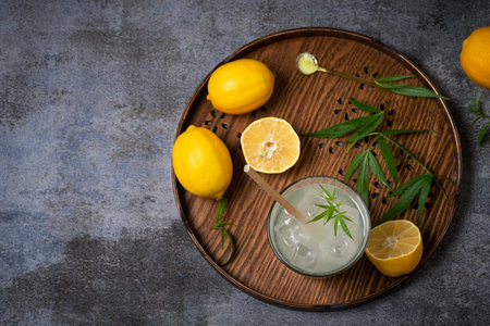 Refreshing homemade lemon juice with marijuana. Non-alcoholic summer cocktail with lemon, cannabis and ice cubesの写真素材