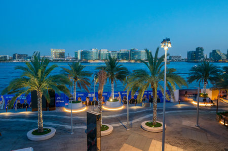 Abu Dhabi, United Arab Emirates - May 3, 2024: Twilight at Al Raha Beach with a view of modern buildings against the Abu Dhabi skyline, highlighting the popular Yas Island area and the bustling seaside boardwalkのeditorial素材