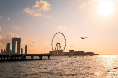 Dubai Marina at sunset on a captivating yacht ride. Witness the enchanting sight of a carousel along...