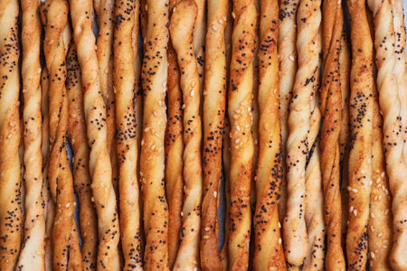 An artistic close-up of twisted bread sticks, providing a rustic and homemade feel perfect for...
