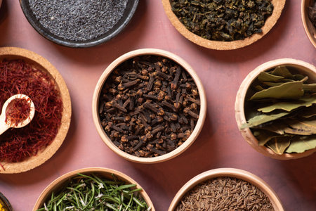 This close-up image highlights whole cloves, capturing their intricate details and deep brown color, essential for imparting unique flavors in various dishes.の写真素材