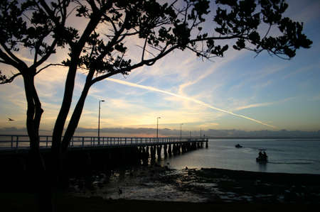 Dawn at waterfront with jetty and fishing boats, Wellington Point, Australiaの写真素材