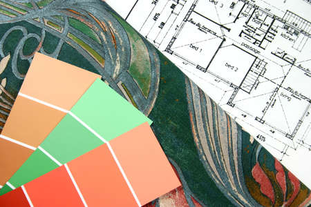 Curtain fabric and paint swatches on top of house floor plan for interior design selection