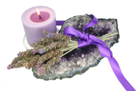 Bunch of lavender on amethyst geode with candle against white backgroundの写真素材