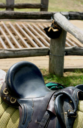 saddle on horse with cattle grid in backgroundの写真素材