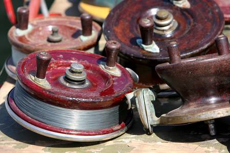 close up of different fishing reels on tableの写真素材