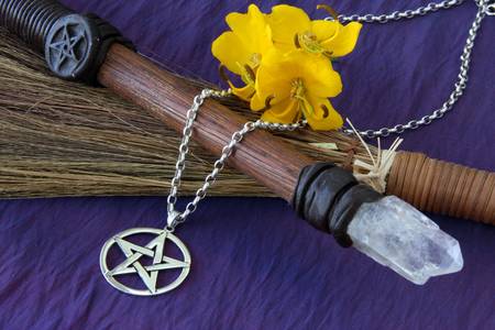 close up of wiccan objects - pentacle pendant wood / crystal wand and straw besomの写真素材
